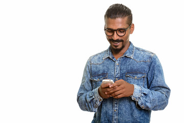 Young happy Indian man using mobile phone 