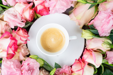 Rose fresh flowers with cup of coffee table from above, flat lay scene with copy space on paper note