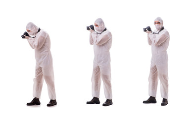 Forensic specialist in protective suit taking photos on white