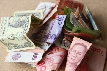 Different currencies from around the world.  This image can be used to represent the concept of foreign exchange or global markets. 