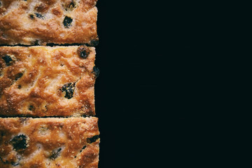 Tasty brown puff pastry witn raisinы background. Flat cookies with c close up