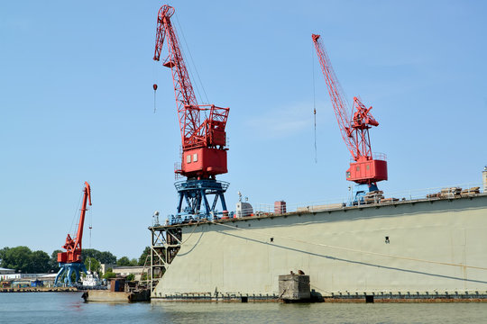  Port cranes and ship dock in port. City Svetlyj, Kaliningrad region