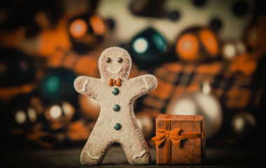 gingerbread man and Christmas gift with toys on background