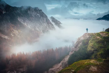 Fotobehang Inspirational photo. Hiker at the top of the hill looking at beautiful autumn mountains. Julian Alps, Slovenia © kovop58