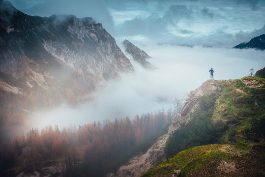 Fototapeta Inspirational photo. Hiker at the top of the hill looking at beautiful autumn mountains. Julian Alps, Slovenia