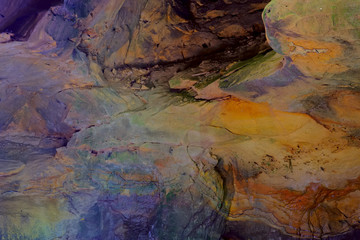 Colorful sandstone rocks and cliffs with live ferns in the deep gorges and rocky valley