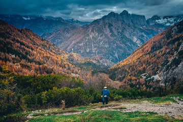 Athlete run up hill in autumn mountains