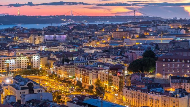 Lisbon after sunset aerial panorama view of city centre with red roofs at Autumn day to night timelapse, Portugal