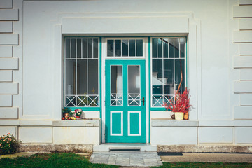 Green glazed door of white house. Beautiful vintage photo