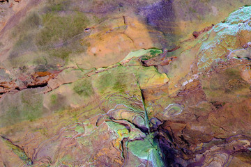 Colorful sandstone rocks and cliffs with live ferns in the deep gorges and rocky valley