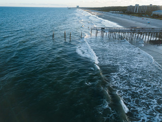 Aerial drone image of a hurricane Storm damaged Fishing pier on the Atlantic Ocean off the South Carolina Coast