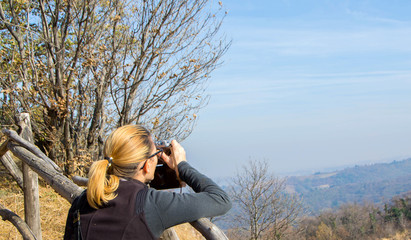 A women takes pictures with the old Soviet rangefinder film camera FED