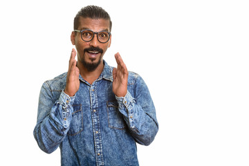Young happy Indian man looking surprised studio portrait against white background