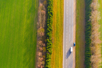 Highway surrounded by hedge aerial view. Travelling concept