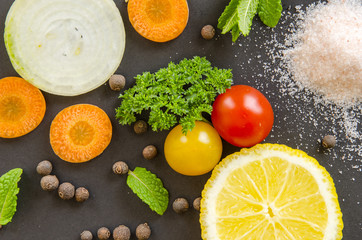 Fresh delicious ingredients for healthy cooking or salad making on dark black background.Top view, banner