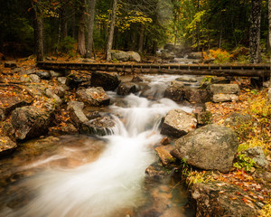 Foot bridge over a rain clogged stream in Autumn