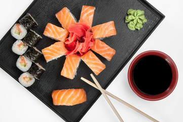 close up of sashimi sushi set with chopsticks and soy on a serving tray