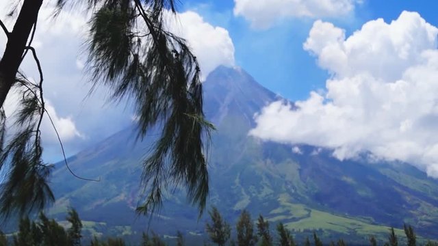 White ash clouds emit from Mayon volcano crater on a clear day. selective focus