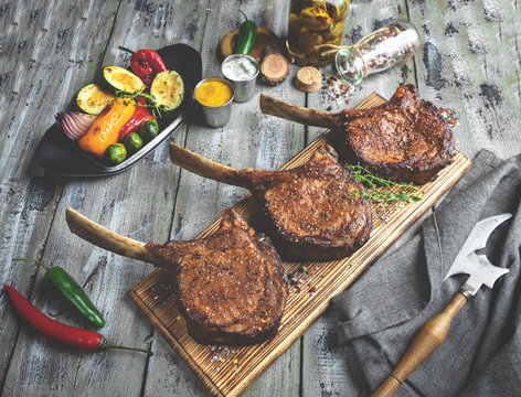 Grilled lamb,mutton meat chops with vegetables on a serving board. Rustic food concept