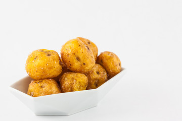 Fried yellow potato (Solanum phureja) isolated in white background