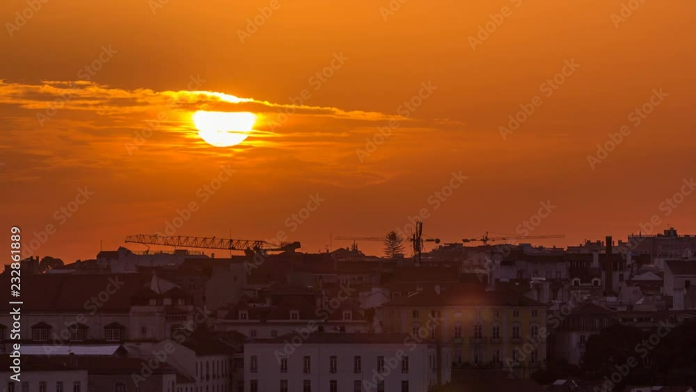 Wall mural lisbon at sunset aerial panorama view of city centre with red roofs at autumn evening timelapse, por