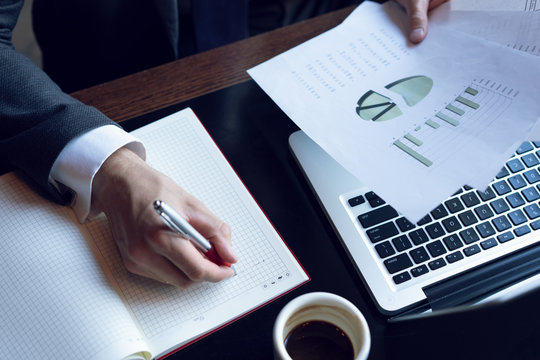 Businessman Analyzing Investment Charts. Accounting. Hands Of Financial Manager Taking Notes While Working.