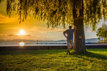 Young man enjoying sunset of Lake Geneva near Montreux city, Lavaux region, Canton Vaud, Switzerland, Europe