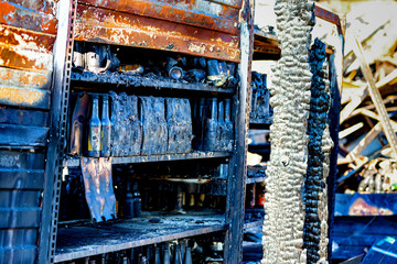 Close up Burned damaged ruins of destroyed bottles on shelf supermarket arson investigation insurance