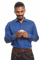 Young happy Indian businessman using mobile phone