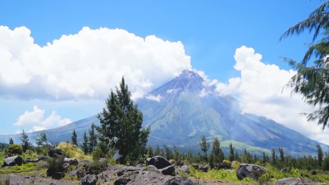 White ash clouds emit from Mayon volcano crater on a clear day