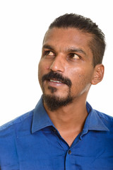 Young Indian businessman thinking studio portrait against white background