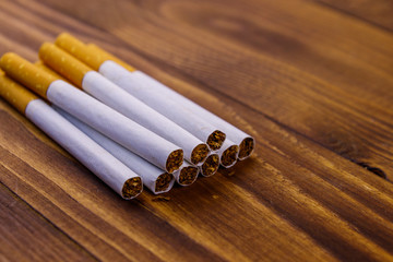Tobacco cigarettes on wooden table