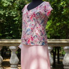 Women's blouse on mannequin. Summer blouse with natural fabric with pattern of feathers. Women's...