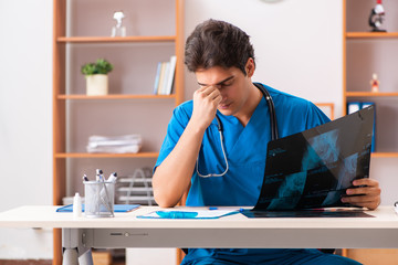 Young handsome doctor radiologyst working in clinic 