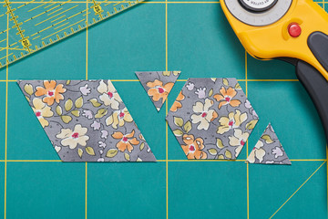 The process of cutting pieces of fabric in the shape of hexagons to create a quilt