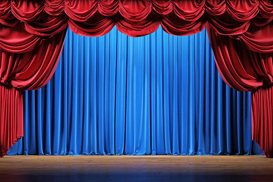 Theater stage with red and blue velvet curtains. 