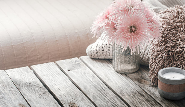 still life from home interior on a wooden background with a candle
