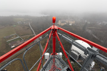 Telecommunication tower or mast with microwave, radio antennas, remote radio units, power cables,...