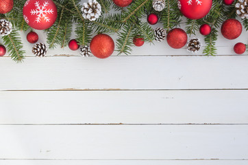 Top view of Fir tree with Pine cones and red balls on wooden table. Christmas decoration background. Flat lay frame mockup