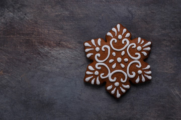 Gingerbread cookies snowflake on dark background, copyspace