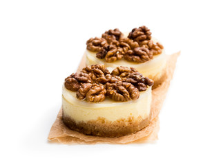 Two mini walnut cheesecake isolated on white