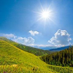 Fototapeta na wymiar green mountain valley under a sparkle sun