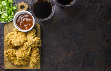 Fried chicken wings on wooden table. Breaded Crispy fried kentucky chicken tasty dinner