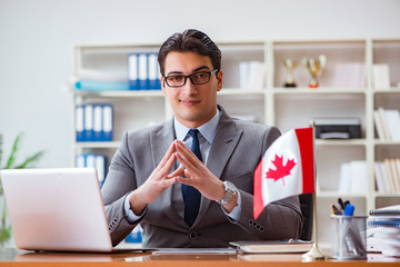 Businessman with Canadian flag in office