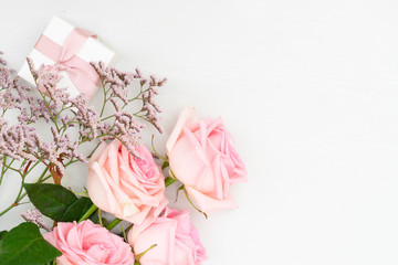 Rose pink fresh flower with gift box on table from above with copy space