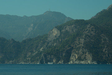 Mountain and sea. coastline with overgrown rocks