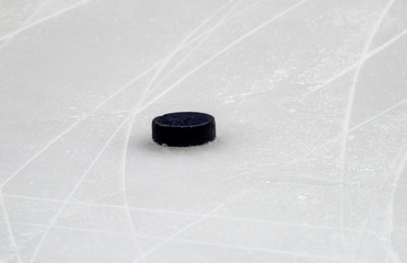Puck on ice hockey rink surface, sport background