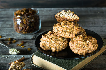 Homemade oatmeal cookies on wooden board on old table background. Healthy Food Snack Concept. Copy space. Still life of food. Christmas cookies. Healthy food. Breakfast concept. raisins