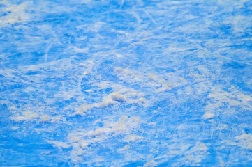 ice background with marks from skating and hockey, blue texture