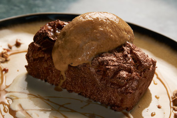 Close up of Chocolate cake with custard and pistachio ice cream